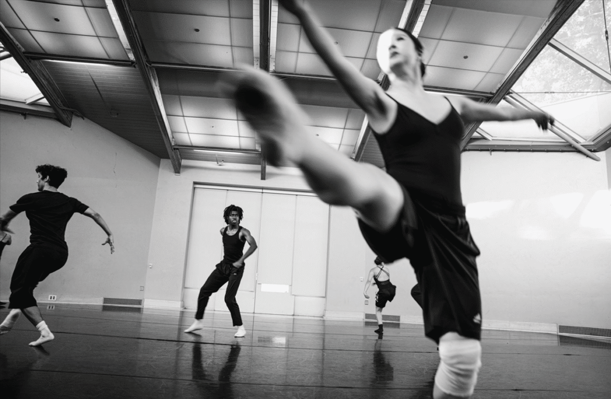 Black and white shot of a ballet dancer with the subject blurred in motion.